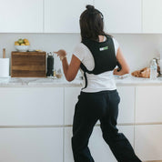 Person using a weighted vest in a kitchen setting