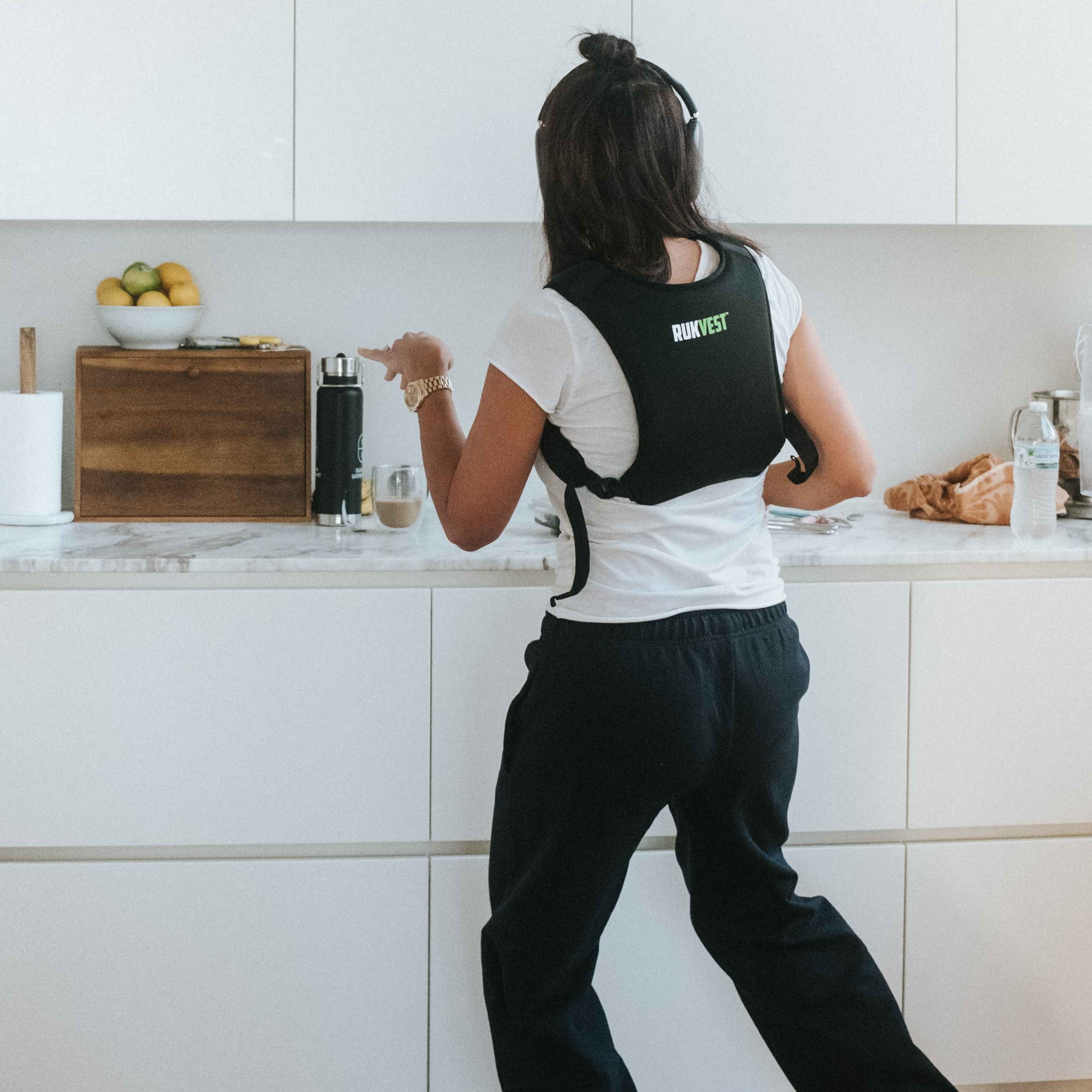 Person using a weighted vest in a kitchen setting