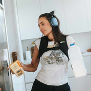 Person wearing weighted vest while putting items away in the fridge